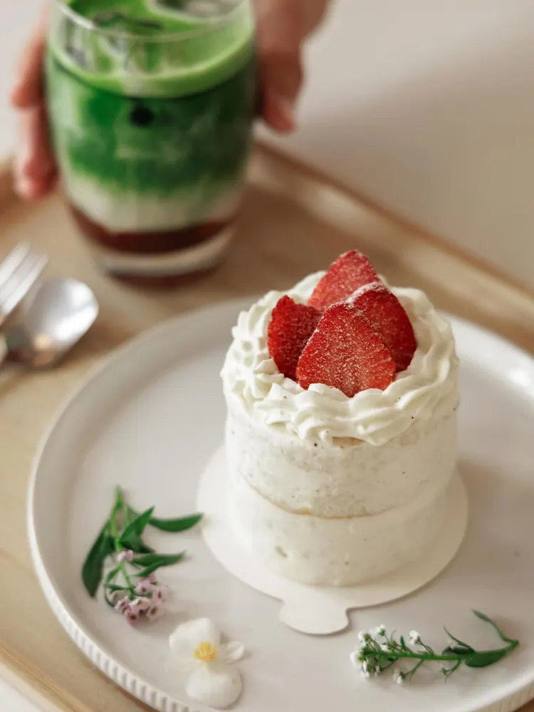 Strawberry shortcake topped with whipped cream and fresh strawberries